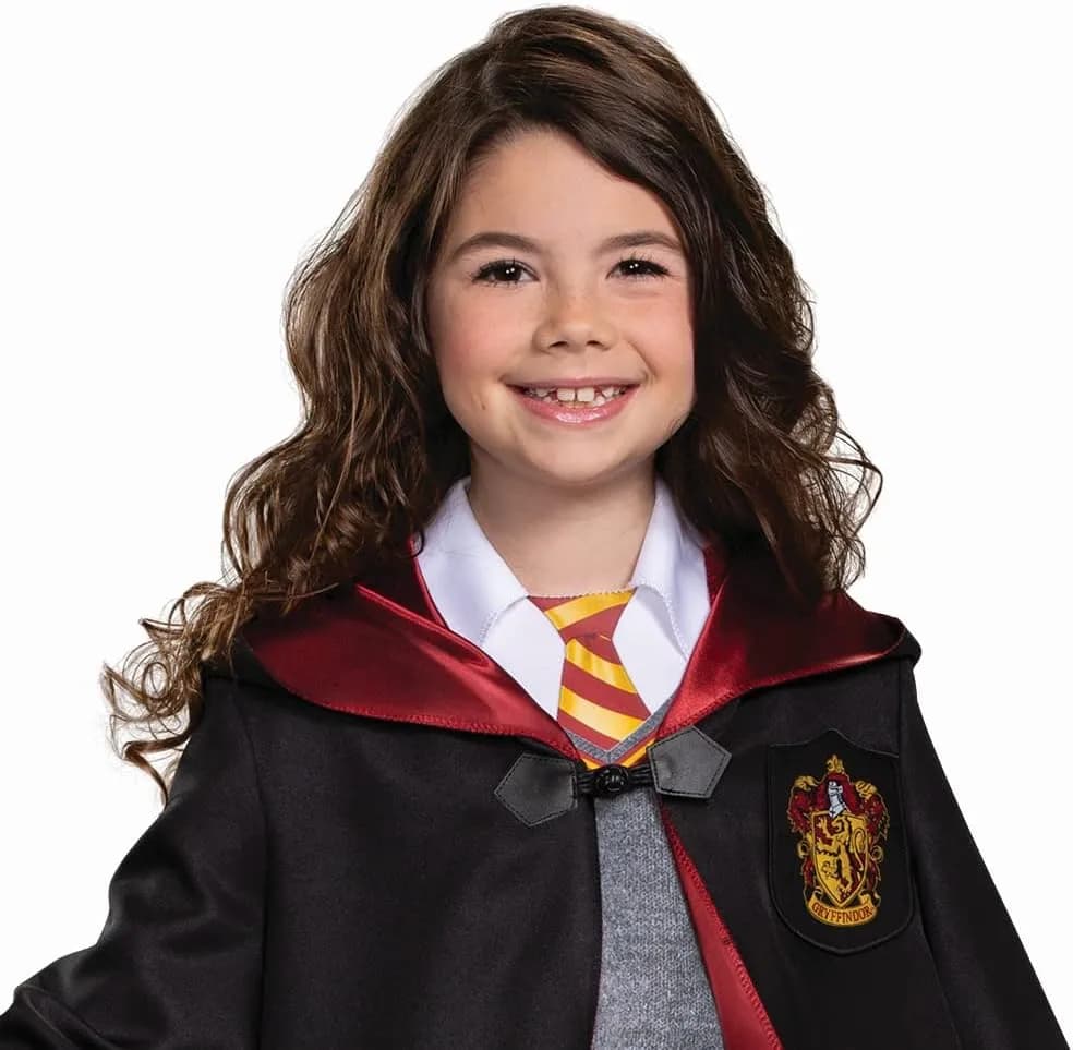 smiling girl in a kids wizard school costume