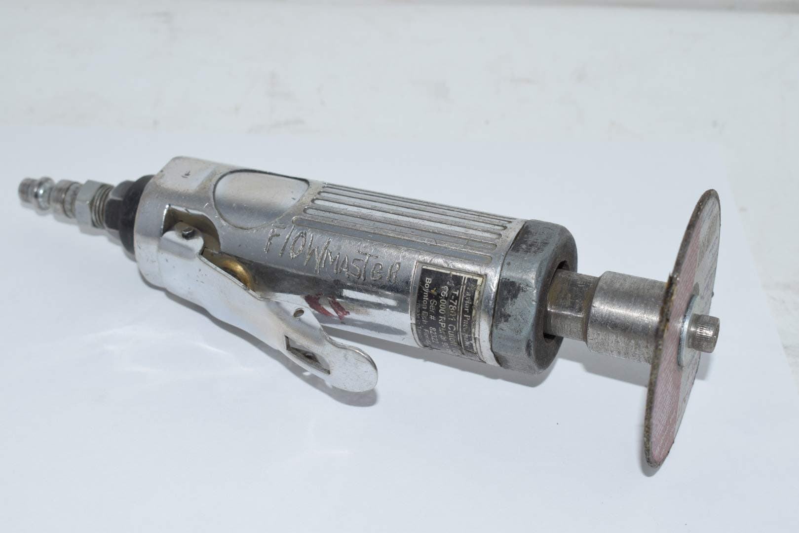 3-inch Flowmaster cutoff tool with metal body, throttle lever, and attached abrasive cutting disc on white background.