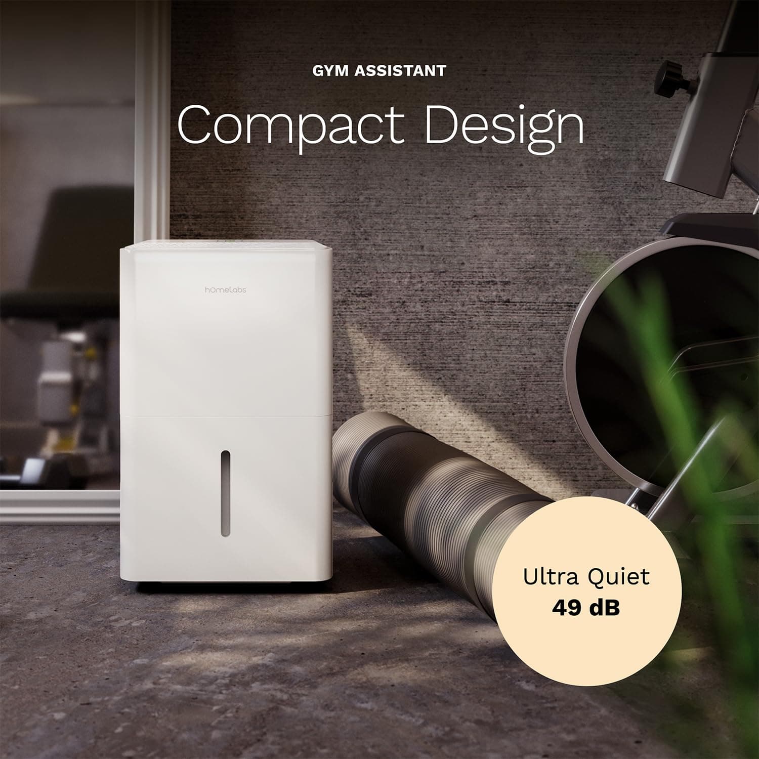 hOmeLabs white dehumidifier with compact design text next to a yoga mat and gym equipment in a home gym setting.